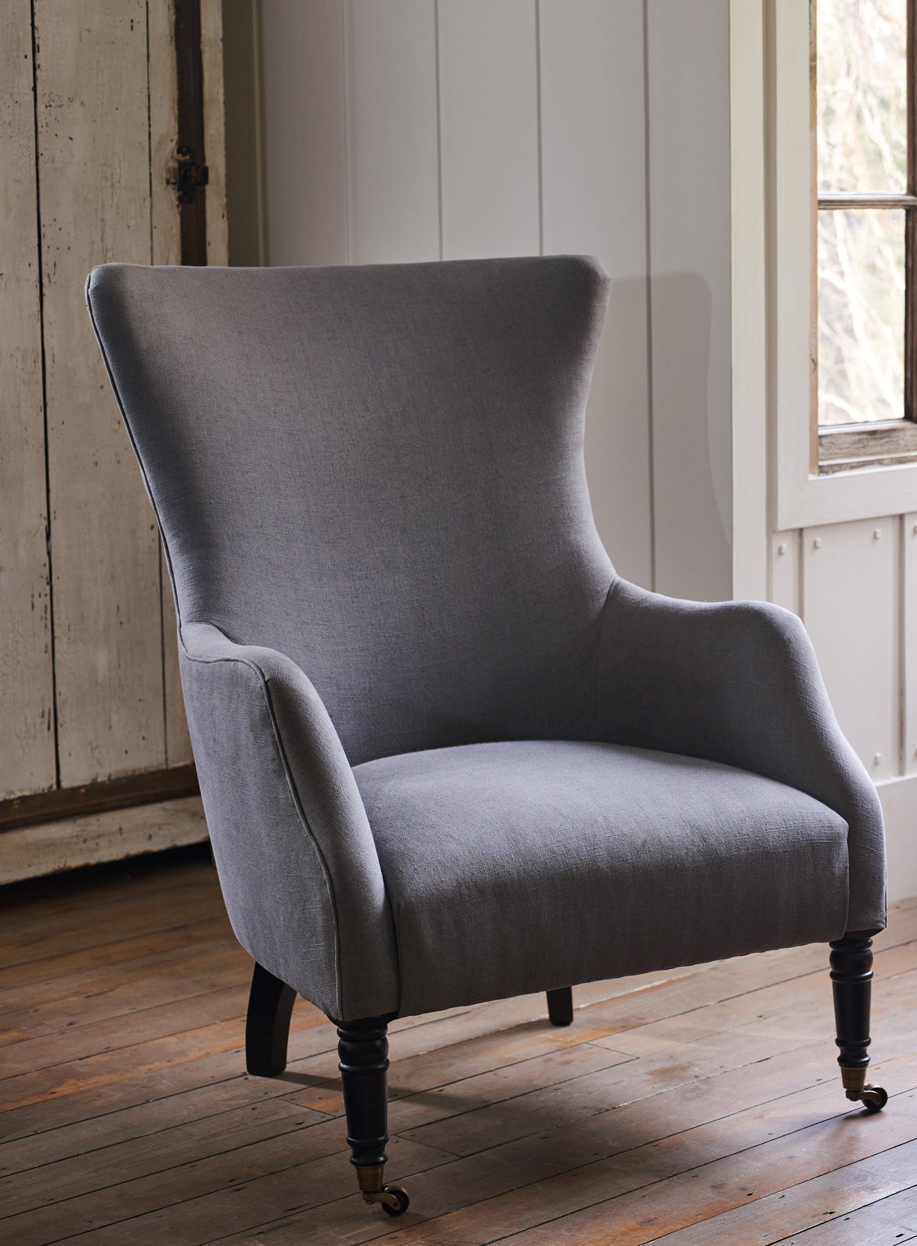 Fauteuil à oreilles Bromley, lin gris (pieds noirs)